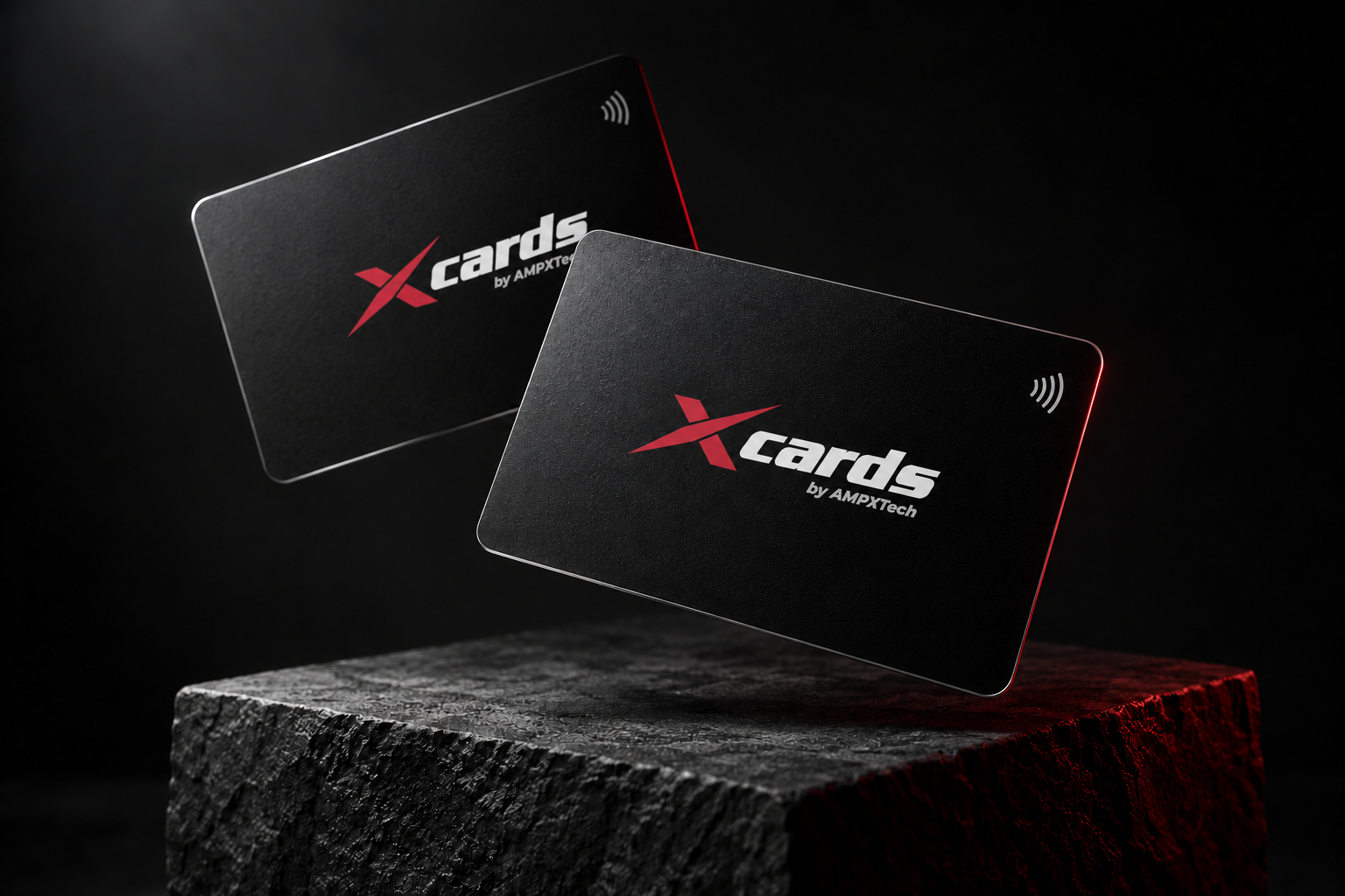 Two matte black NFC business cards featuring the official xCards by AMPXTech logo